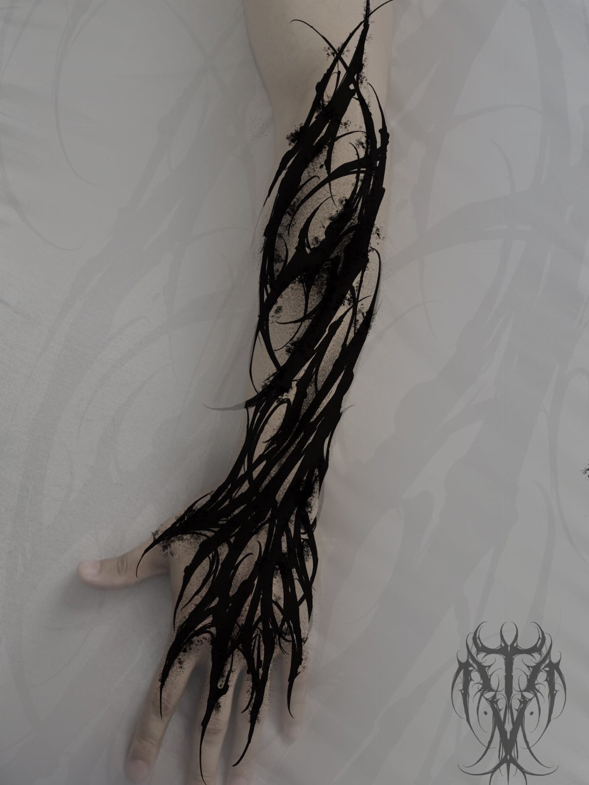 Abstract black ink tattoo of sharp organic shapes on a forearm and hand.