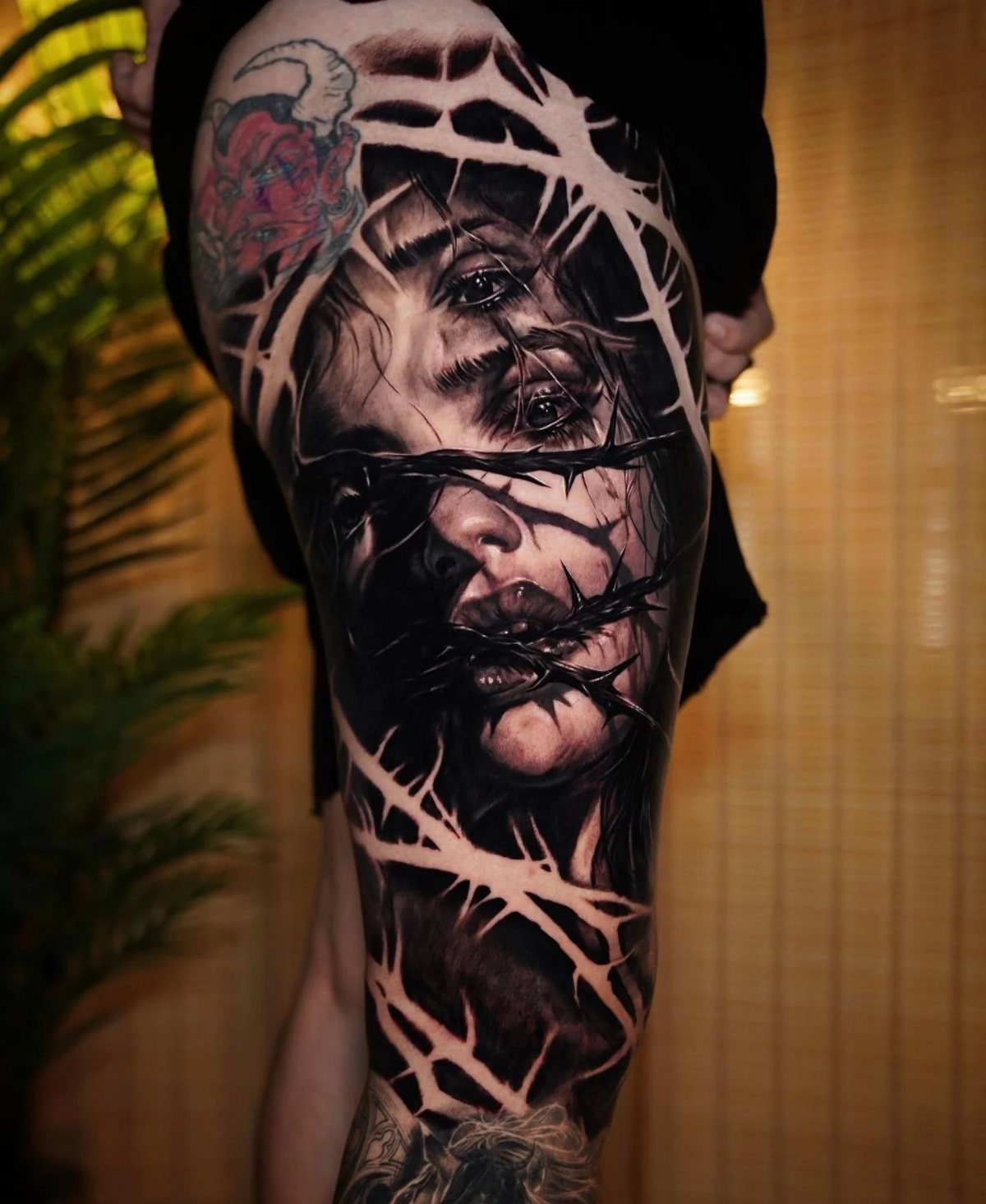 Surreal black and grey tattoo of a woman's face fragmented by white shards
