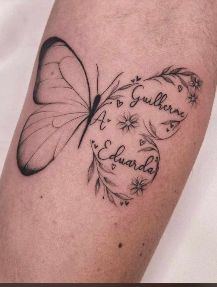 Butterfly tattoo with a floral heart containing the cursive names Guilherme and Eduarda.