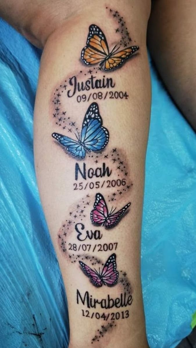 Colorful butterfly tattoos with names and dates on a person's forearm.