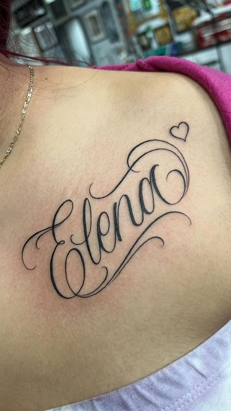 Ornate Chicano style tattoo of the name Elena on a person's upper back