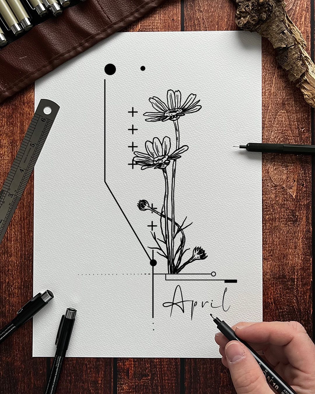 Daisy flower tattoo design with the word April written in cursive script.