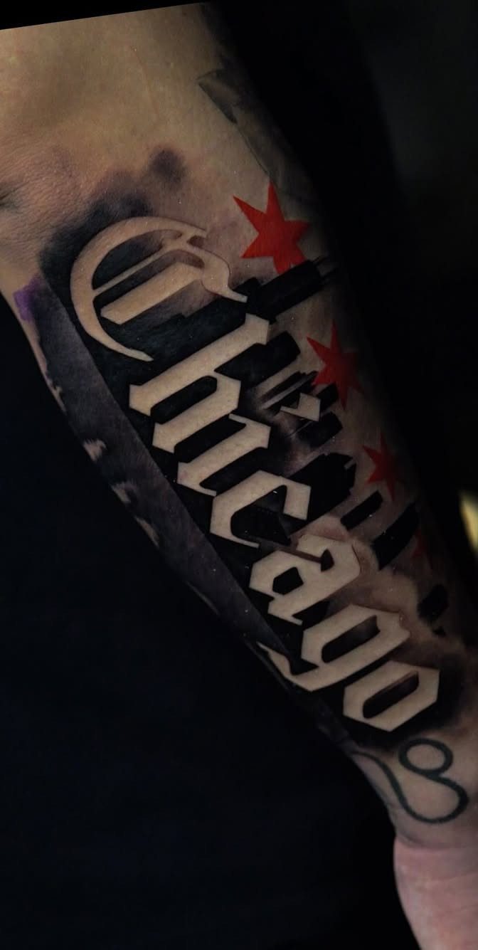 Chicago tattoo in Old English font with red stars on a person's arm