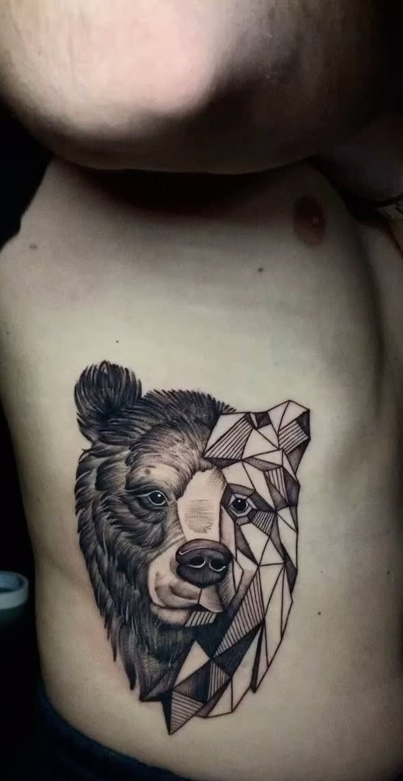 Bear head tattoo on chest with one side realistic and one side geometric