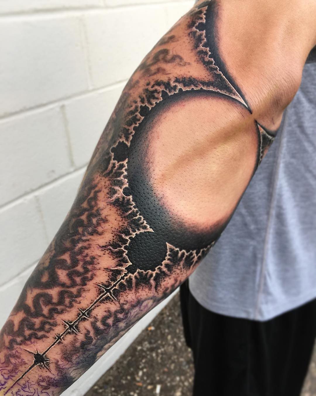 Detailed fractal tattoo on a person's arm with complex repeating geometric patterns.