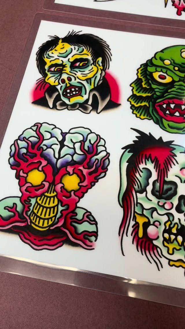 Tattoo flash sheet with colorful horror illustrations of zombies and monsters on white paper.