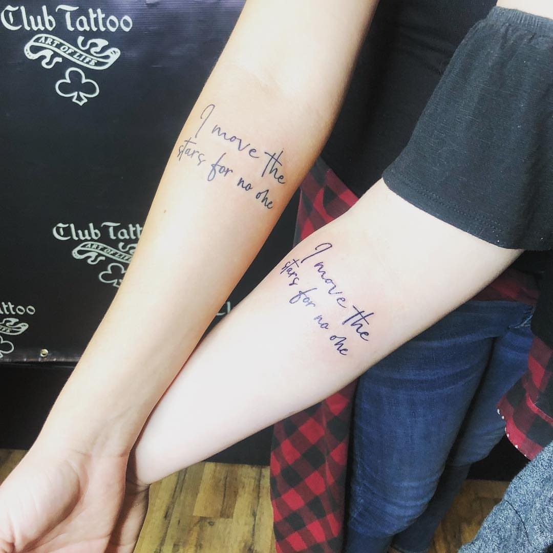 Matching cursive quote tattoos on two forearms reading I move the stars for no one