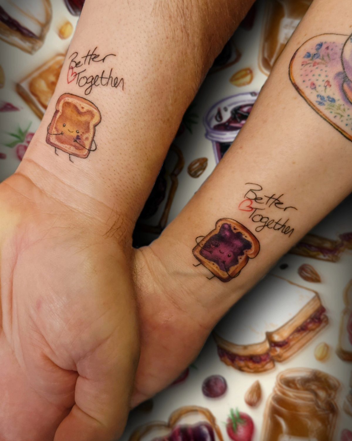 Matching peanut butter and jelly toast tattoos on two wrists with Better Together text.