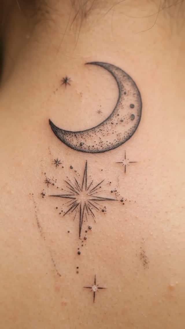 Crescent moon and stars tattoo with stippled shading on a person's skin.