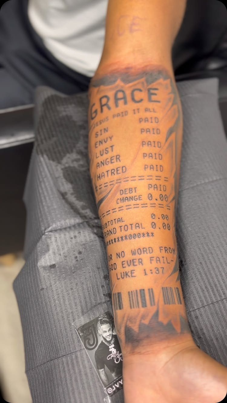 Forearm tattoo designed as a receipt featuring a Bible verse from Luke 1:37.