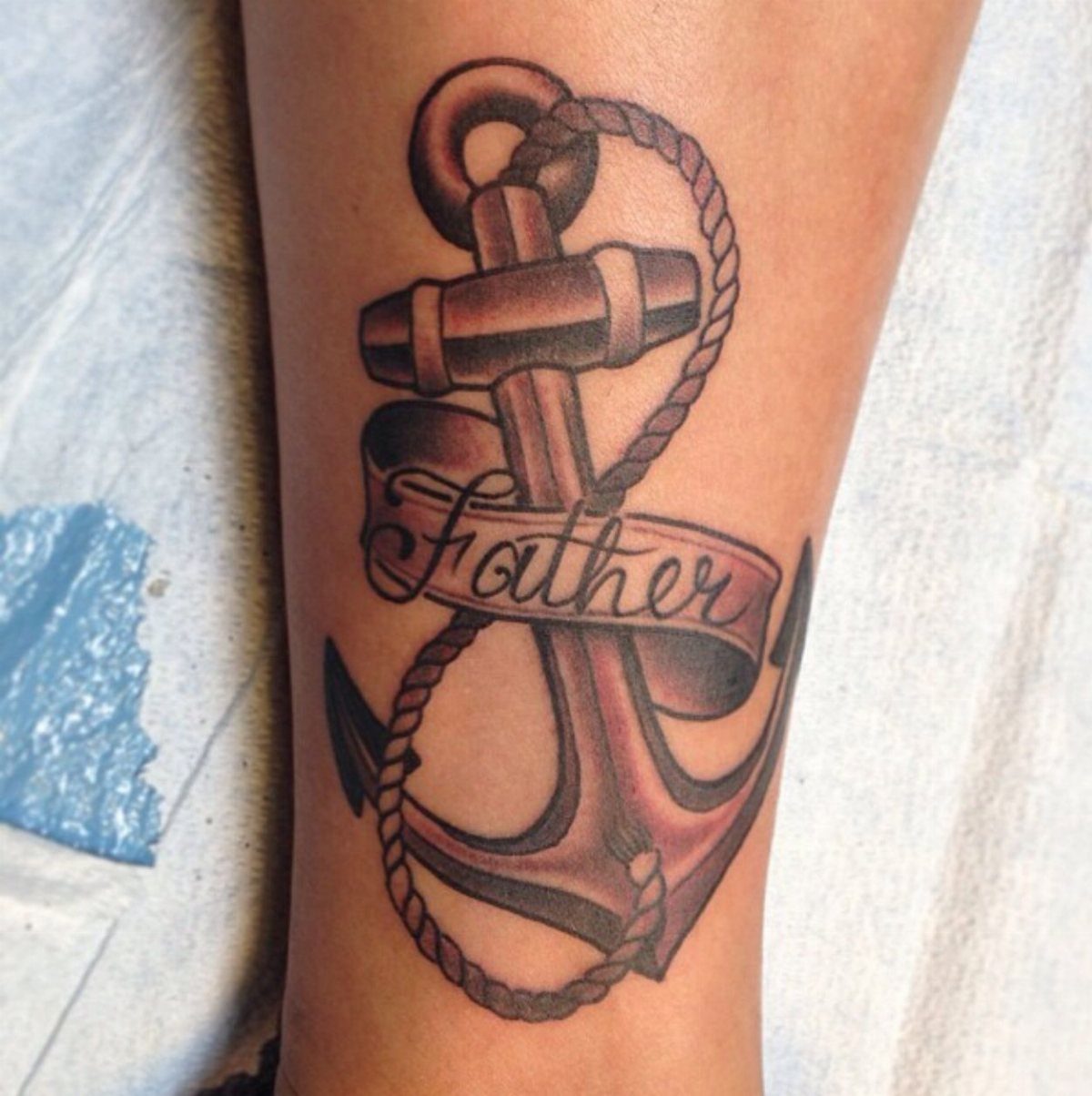 Anchor tattoo on skin with a rope and a banner reading Father