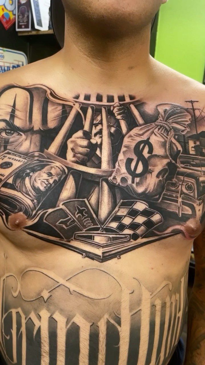 Black-and-gray chest tattoo featuring a money bag, prison bars, and Chicano imagery.