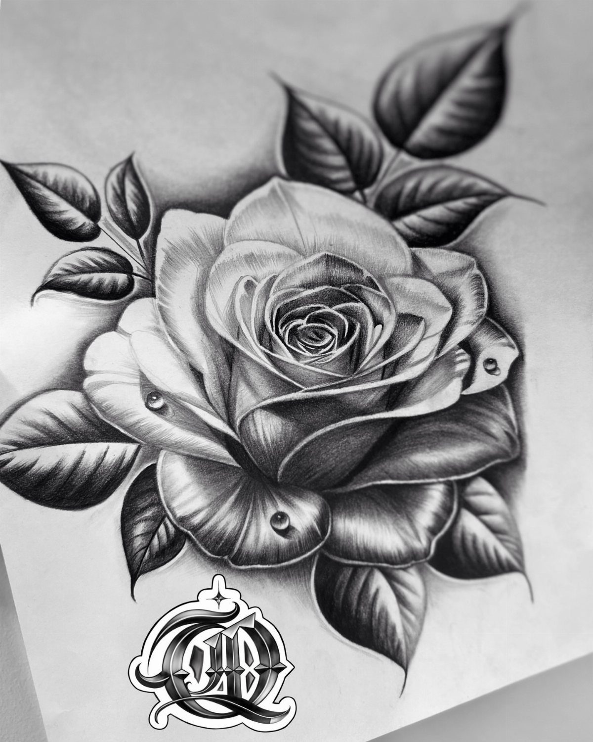 Detailed black and gray drawing of a blooming rose with leaves and dew drops.