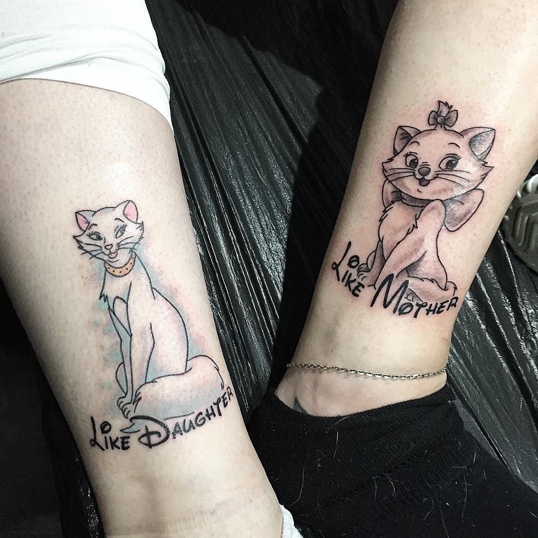 Matching Disney cat tattoos on two arms with Like Mother Like Daughter text