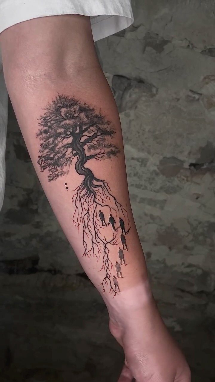 Tree tattoo on a leg with human silhouettes integrated into the root system