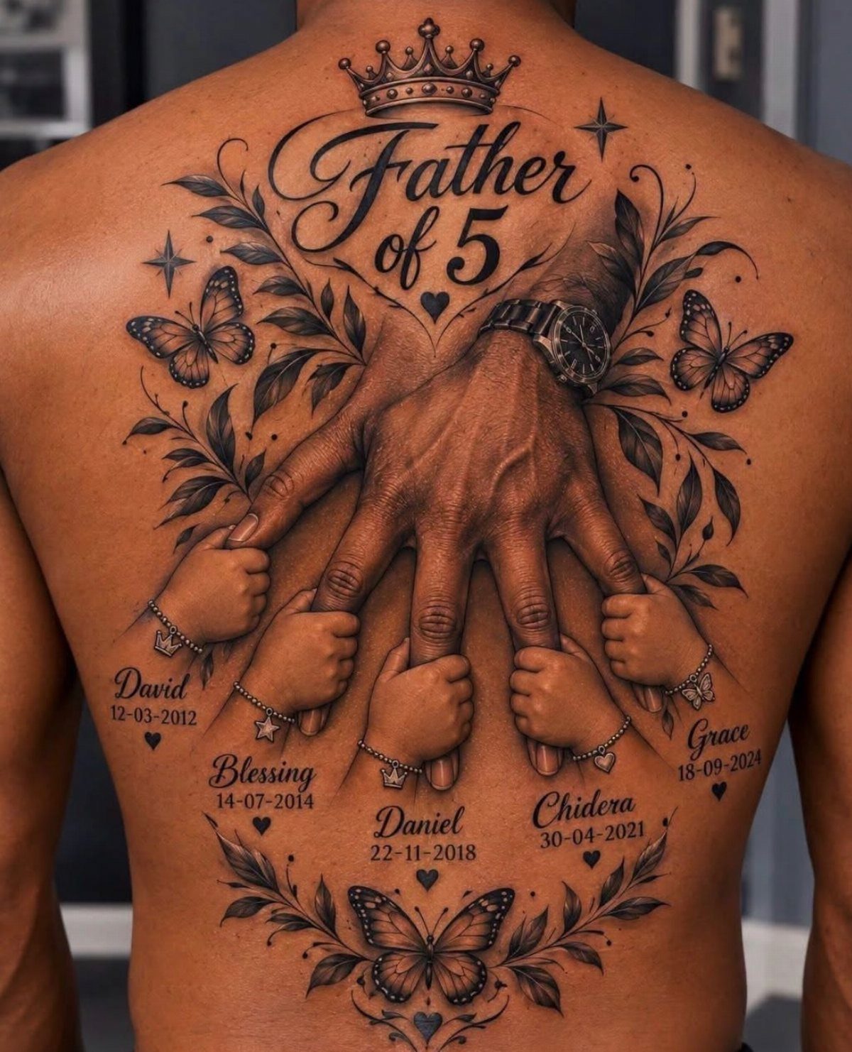 Tattoo on a man's back showing a father's hand holding five children's hands with names.