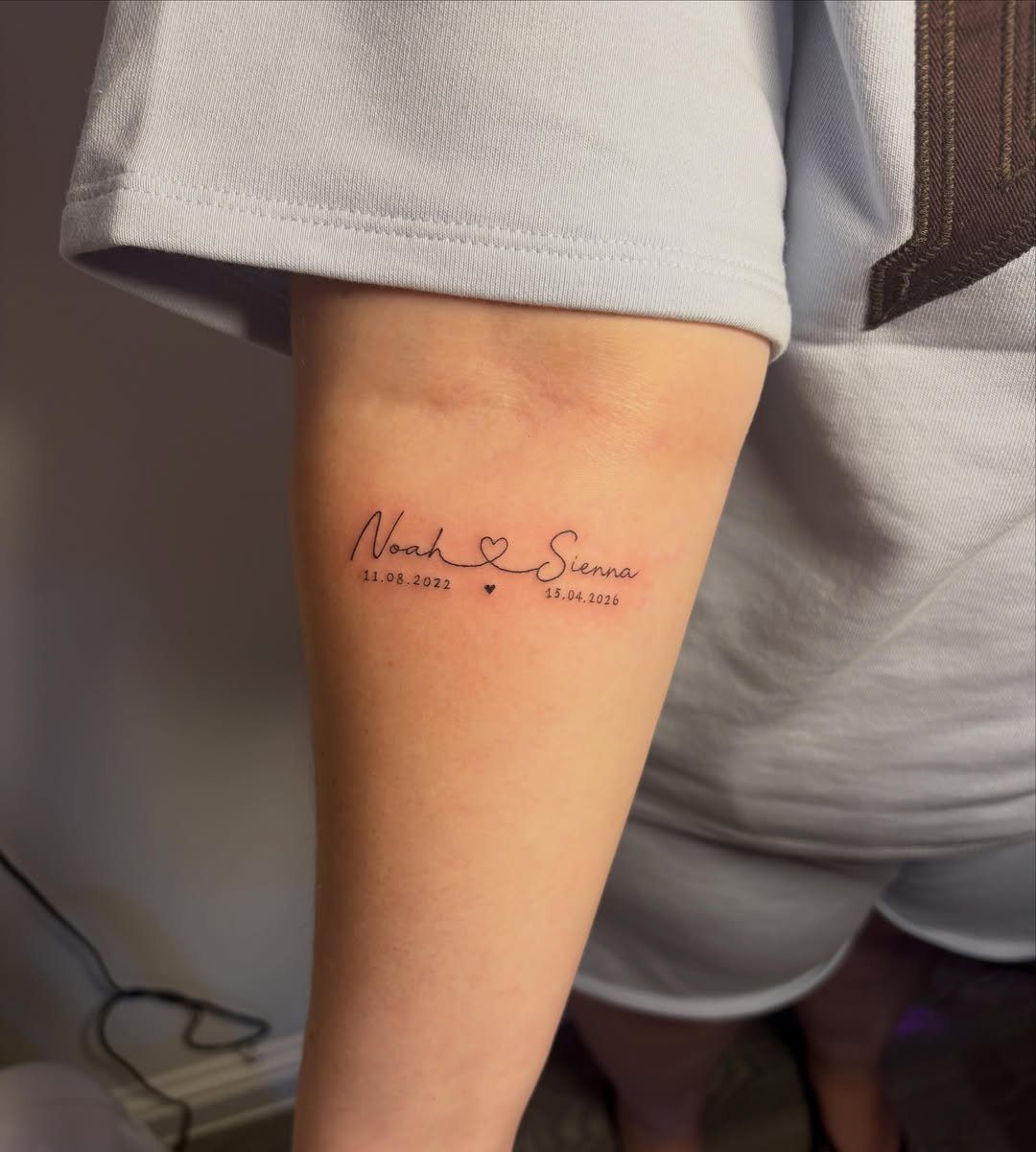 Cursive tattoo of names Noah and Sienna with small hearts on an arm