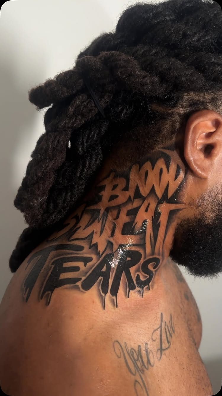 Bold black ink tattoo on a neck reading BLOOD SWEAT TEARS in dripping style