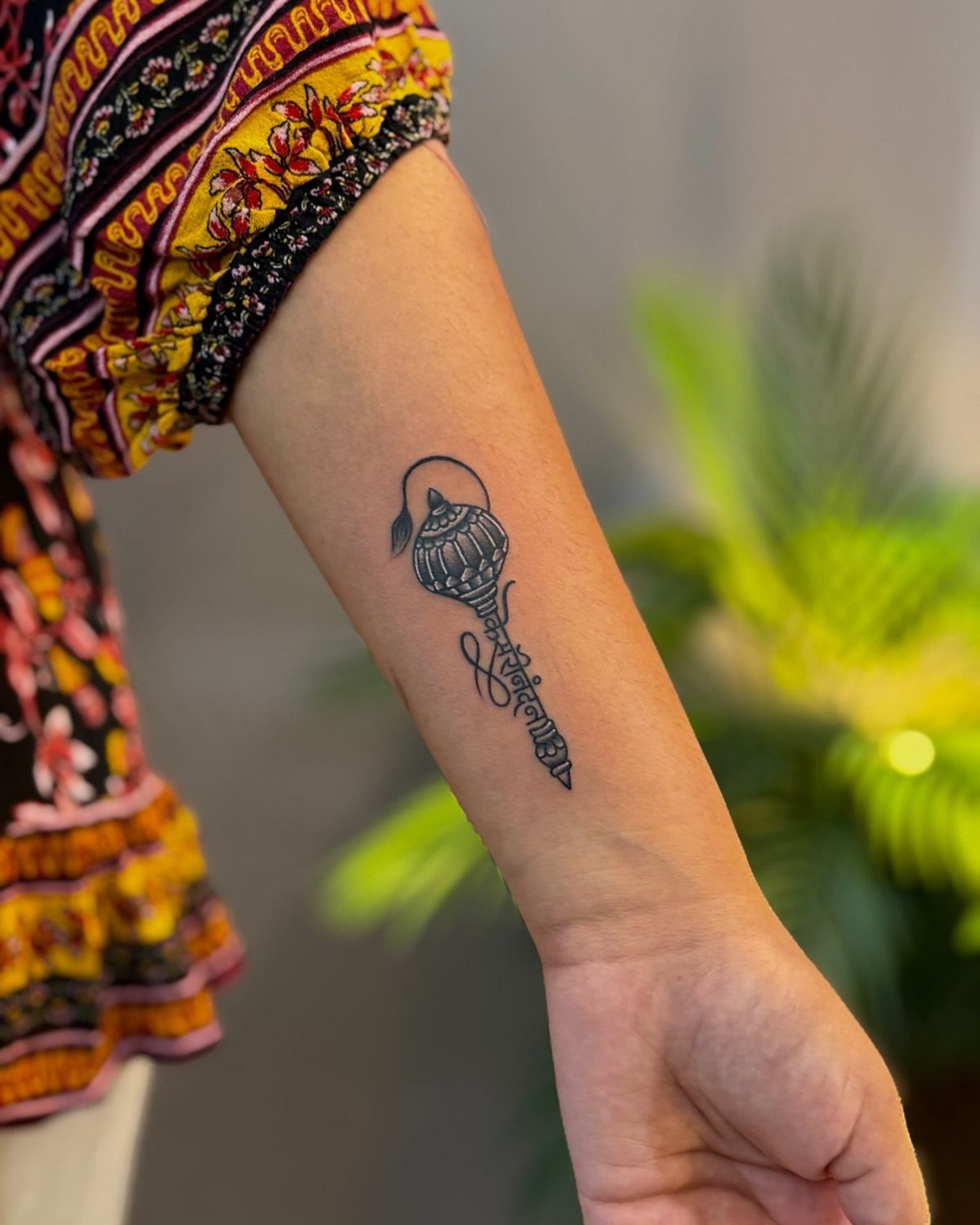 Gada mace tattoo on a forearm symbolizing the strength of Lord Hanuman