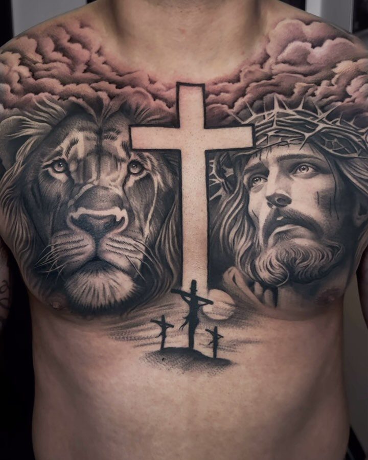 Chest tattoo featuring a white cross, a lion, and Jesus with crown of thorns.
