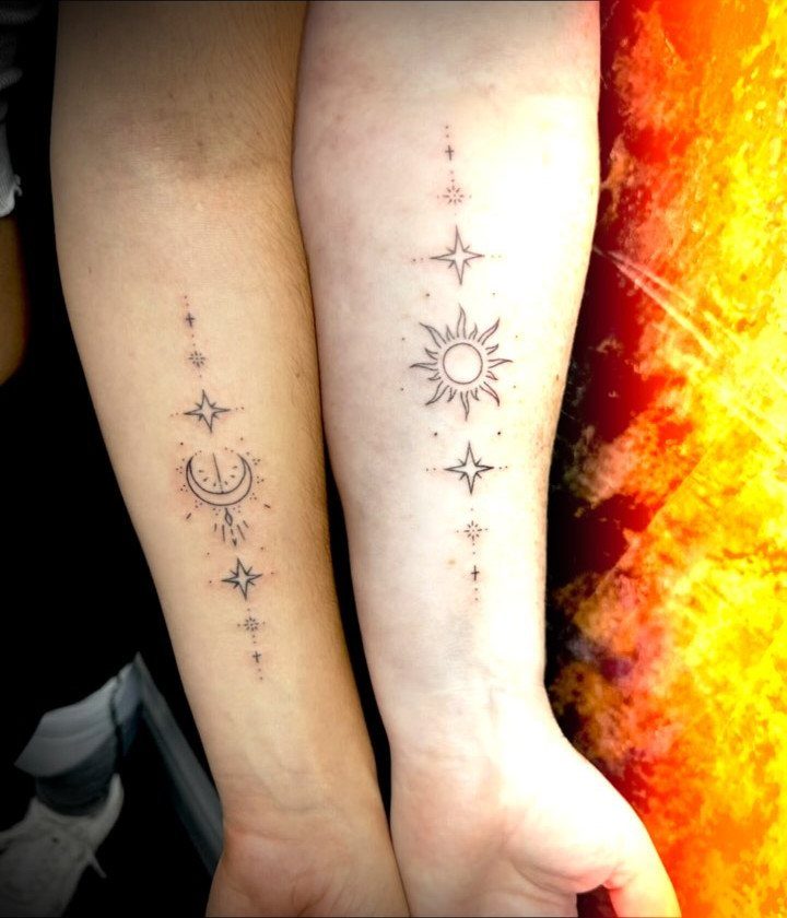 Matching sun and moon tattoos with stars on two people's forearms.