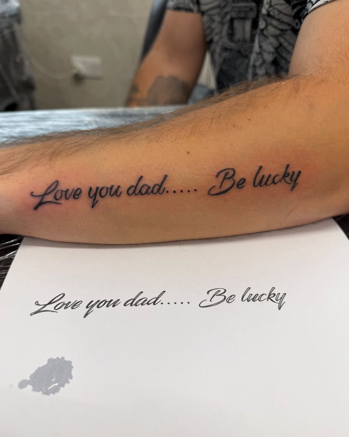 Forearm tattoo of the phrase Love you dad Be lucky based on handwriting