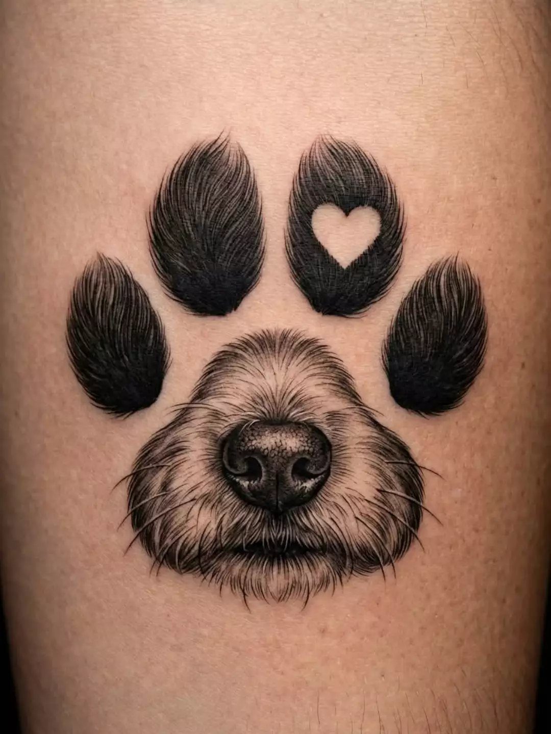 Dog paw print tattoo with a realistic nose and a small heart detail