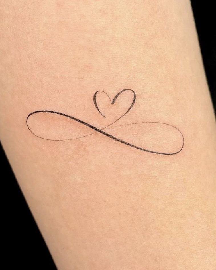 Infinity symbol tattoo with a small heart integrated into the top line.