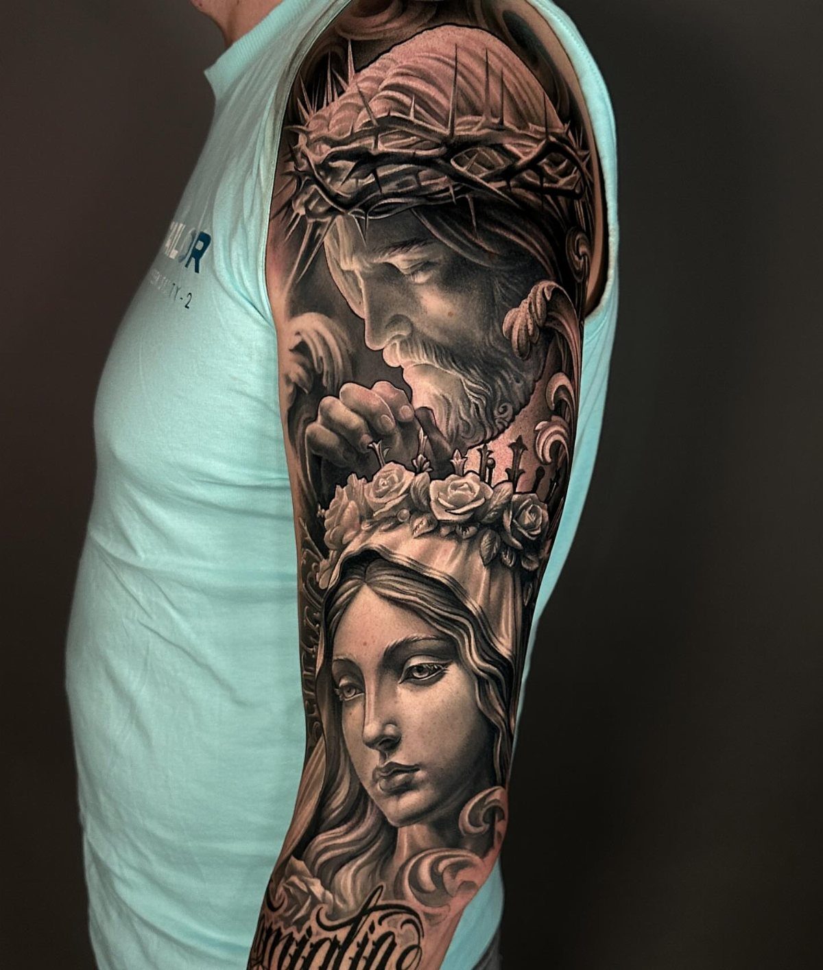 Tattoo of Jesus with crown of thorns and Virgin Mary on an arm