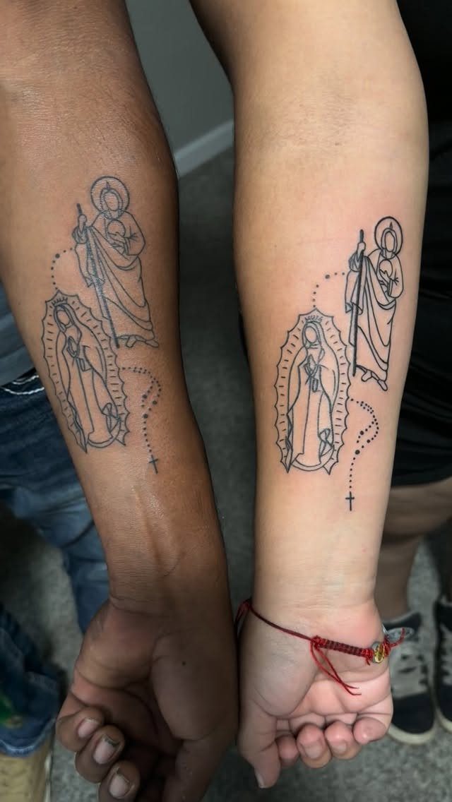 Matching forearm tattoos of the Virgin Mary and Saint Jude Thaddeus in black ink.